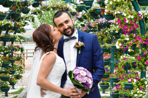 Happy bride and groom on their wedding hugging and kissing.