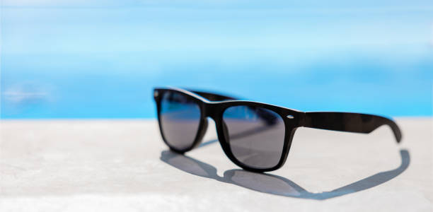 istock Sunglasses on blurry sea background 1384468345