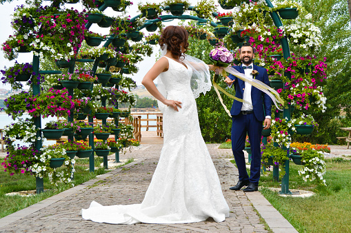 Happy bride and groom on their wedding hugging and kissing.