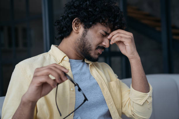 istock Tired Indian businessman having headache sitting in office. Man fired from work. Depression, overwork concept 1384481227