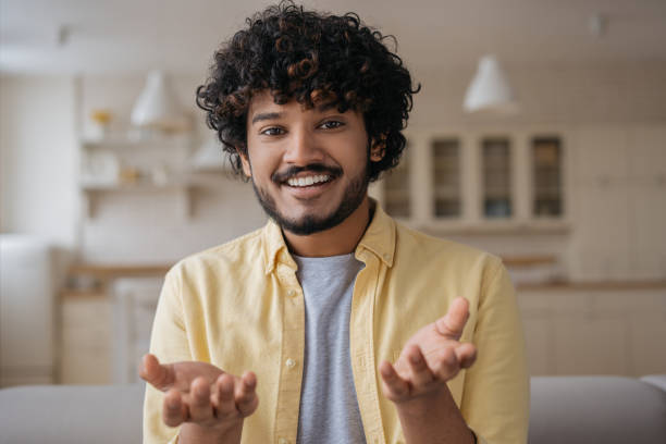 istock Smiling Indian man having video call. Handsome young freelancer communication online working from home, video conference concept. Successful asian influencer recording video talking to camera 1384481967