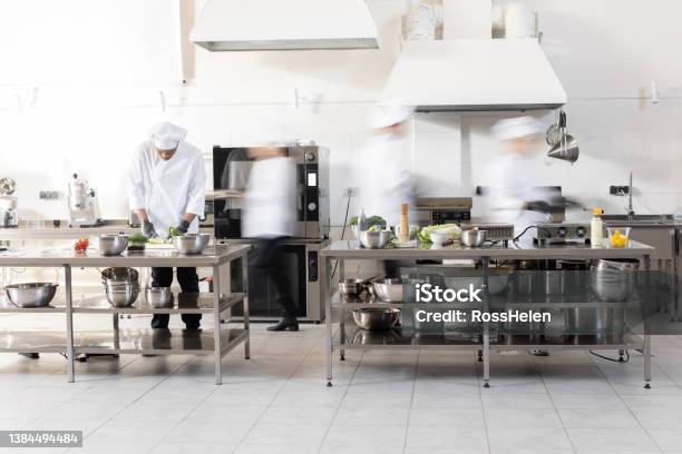 Chef Cooks Working In Professional Kitchen Stock Photo - Download Image Now - Blurred Motion, Busy, Commercial Kitchen