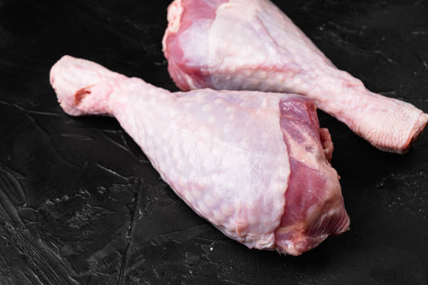 istock Raw turkey legs ingredients, on black dark stone table background 1384496667