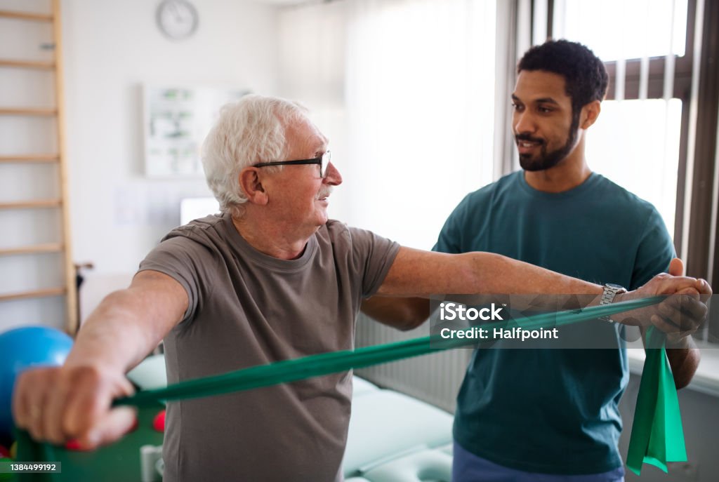 Young physiotherapist exercising with senior patient in a physic room A young physiotherapist exercising with senior patient in a physic room Physical Therapy Stock Photo