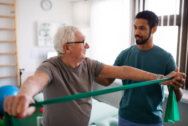 Young physiotherapist exercising with senior patient in a physic room A young physiotherapist exercising with senior patient in a physic room physical therapy stock pictures, royalty-free photos & images