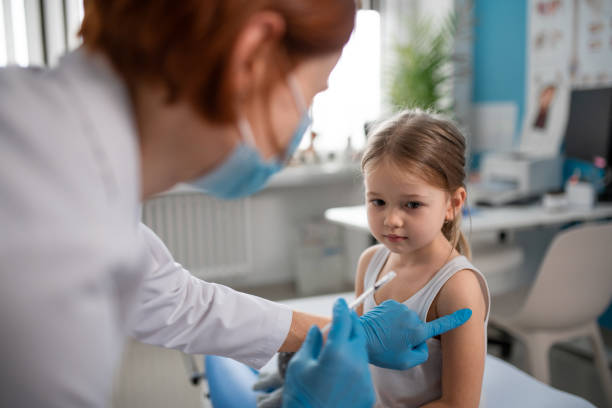 istock Worried little girl getting vaccinated in doctor's office. 1384499746