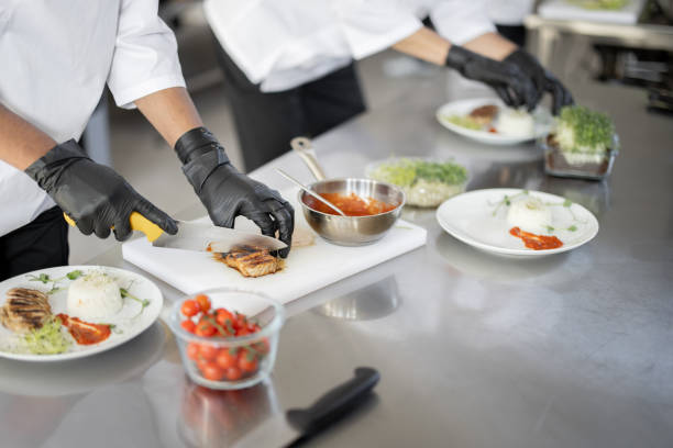 istock Cooks finishing main courses in the restaurant kitchen 1384511453