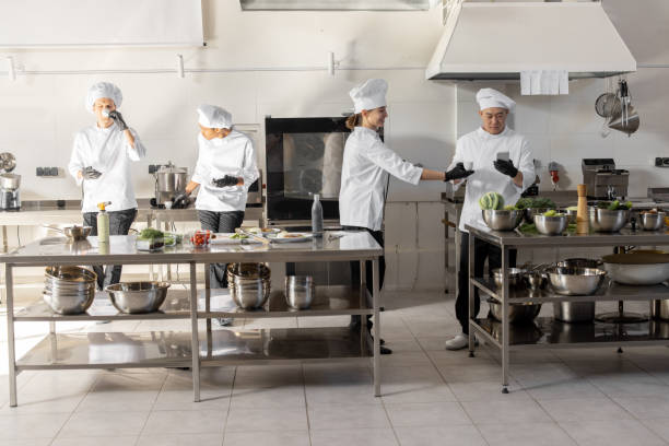 istock Group of cooks during a coffee break in the restaurant kitchen 1384515774