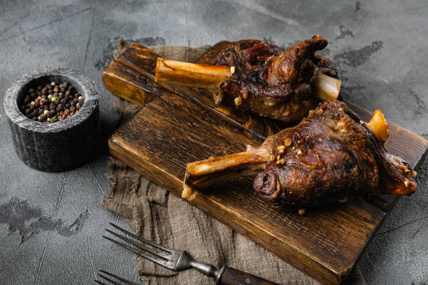 istock Slow Cooked Lamb Shanks meat, on gray stone table background 1384515920