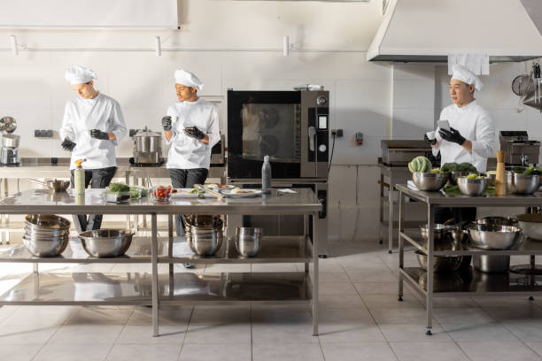 istock Group of cooks during a coffee break in the restaurant kitchen 1384515960