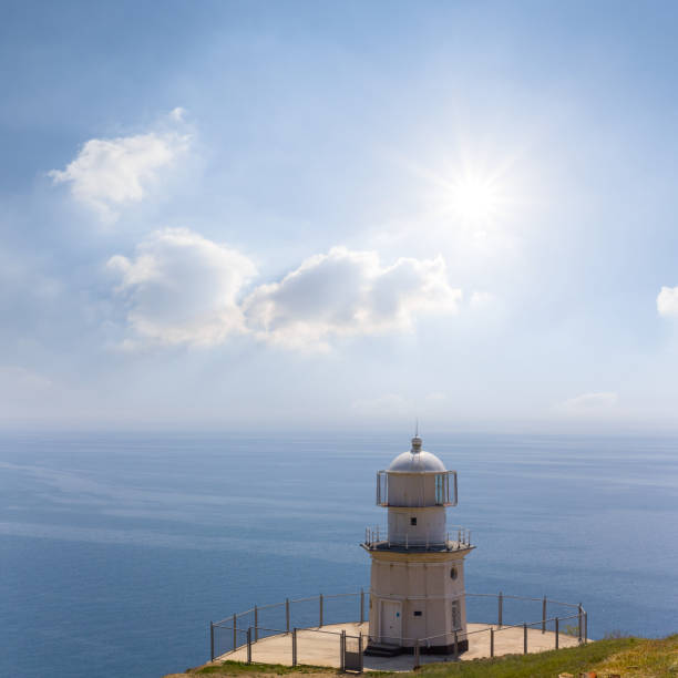 istock lighthouse on marine cape at sunny day 1384527370