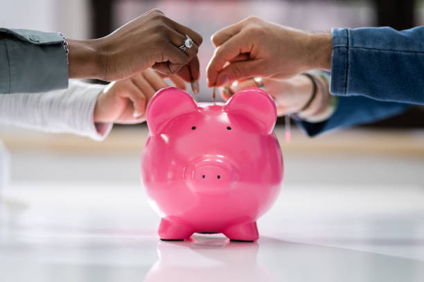 istock Crowdfunding Concept. People Inserting Coins Into 1384530131