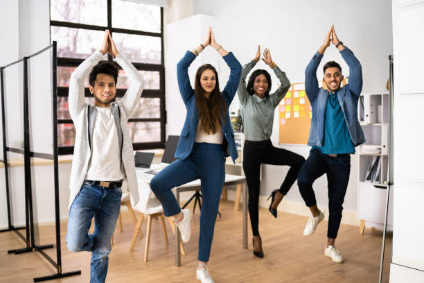 istock Business People Exercising In Office 1384530149