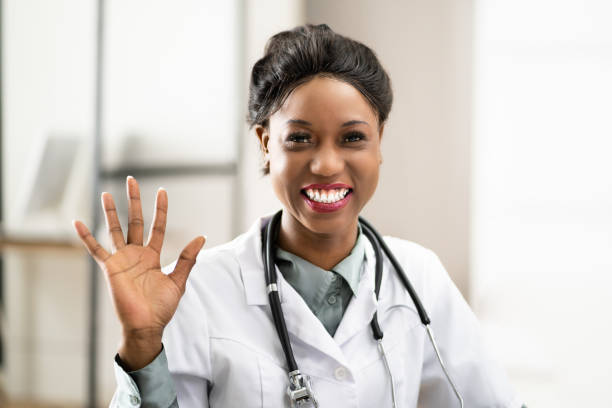 istock Doctor Waving In Online Video Call 1384530174