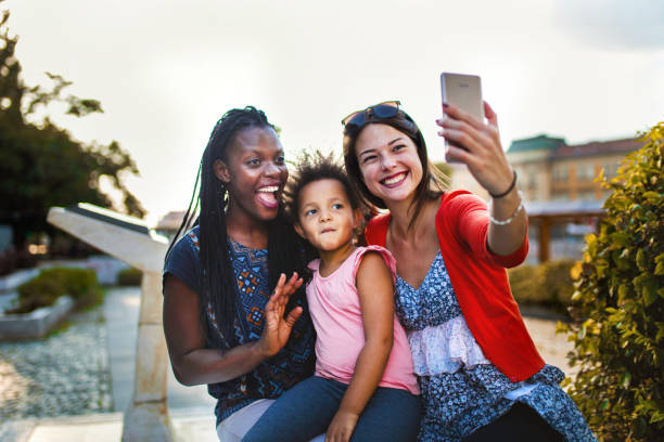 istock Taking selfies on a sunny day in city park 1384533622