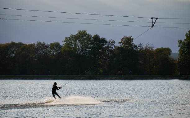 istock Young surfer having fun wakeboarding in the cable park. 1384533830