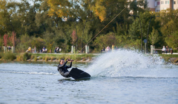 istock Young surfer having fun wakeboarding in the cable park. 1384533839