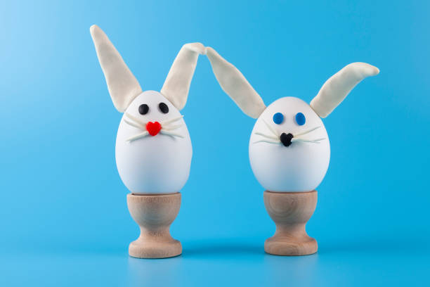 istock Easter eggs in the form of a rabbit on wooden stands 1384541793
