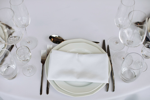 Classic white decor of a festive dinner table in a restaurant