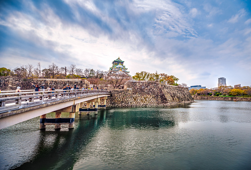 Osaka, Japan - March 28, 2019 : Tourists on Gokurakubashi Bridge over moat surrounding Osaka Castle, Japan