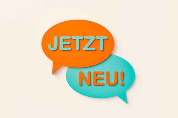 istock Jetzt neu (now new). Speech bubble in orange and blue against a white wall. 1384548345