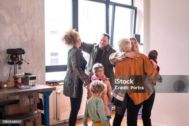 Couple Welcoming Guests For Diner Party At Home Stock Photo - Download Image Now - Family, Meeting, Social Gathering