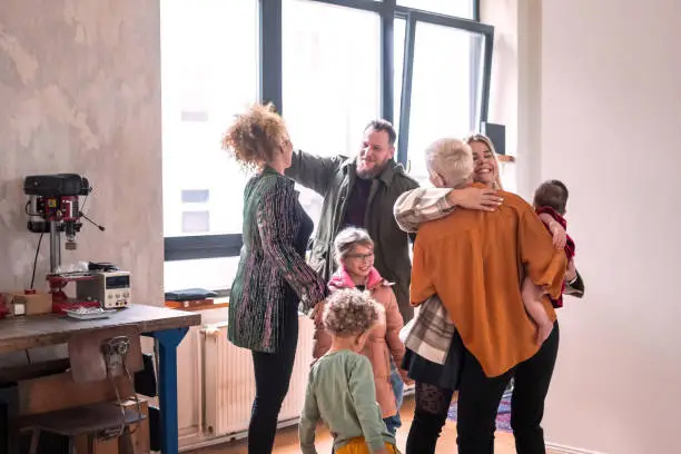 Photo of Couple welcoming guests for diner party at home