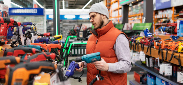 istock builder in a power tool store chooses a new drill and screwdriver 1384554640
