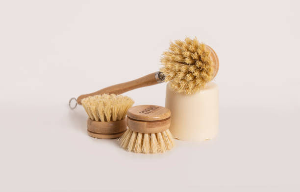 istock Bamboo dish brushes with a block of soap on a light background 1384554723