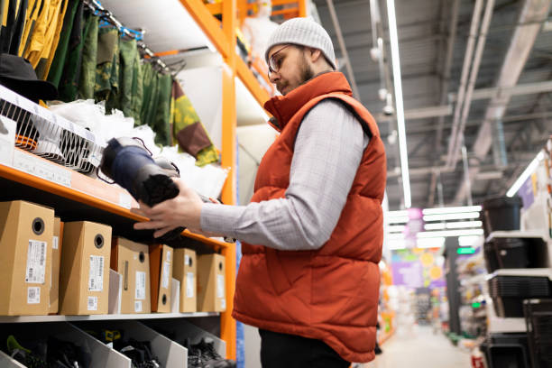 istock hardware store customer chooses shoes to work on a construction site with impact protection 1384555902