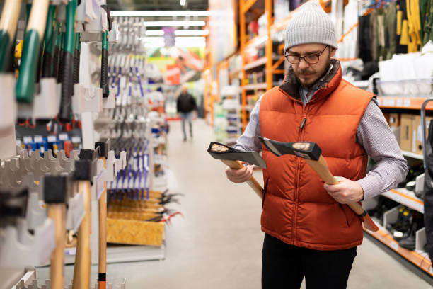 istock a customer in a hardware store compares two axes 1384556373