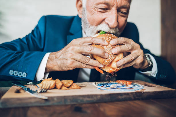 istock Senior businessman at restaurant table 1384561388