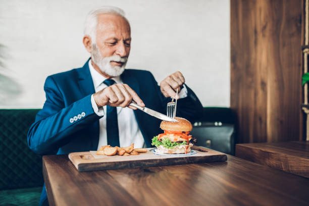 istock Senior businessman at restaurant table 1384561390