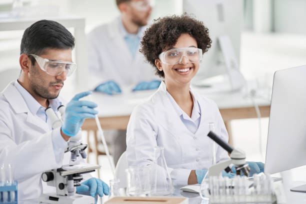 istock smiling female scientist at the workplace in the laboratory 1384570307