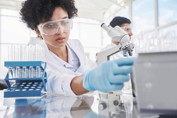 istock female scientist and her colleagues work in a medical laboratory 1384570314