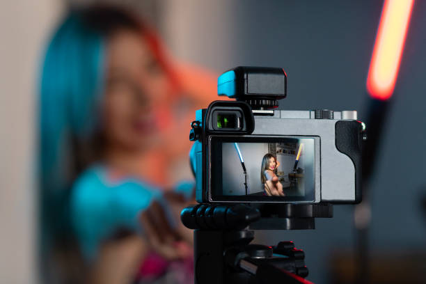 istock Caucasian woman streaming a session with her camera at home 1384570575