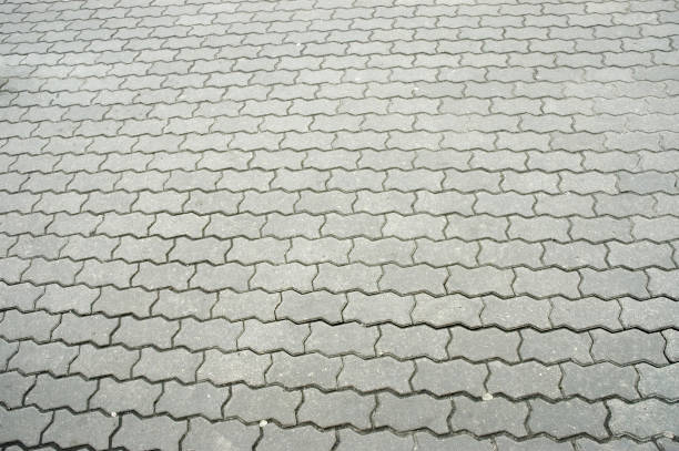 istock Texture of pavement, paved with patterned stone tiles. 1384571365