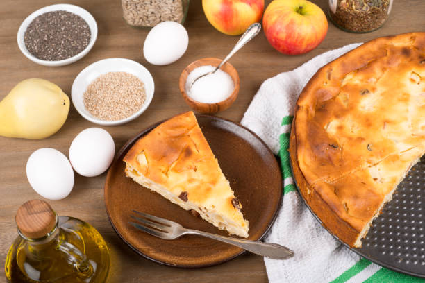 Cheesecake with raisins and apples on a table with ingredients