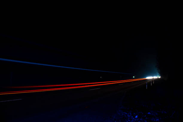 istock Red and white lights from passing cars. Night highway. 1384579580