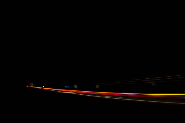 istock Red and white lights from passing cars. Night highway. 1384580636