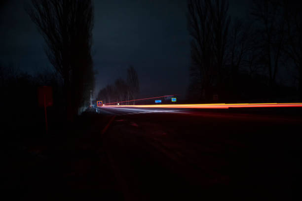istock Red and white lights from passing cars. Night highway. 1384581154