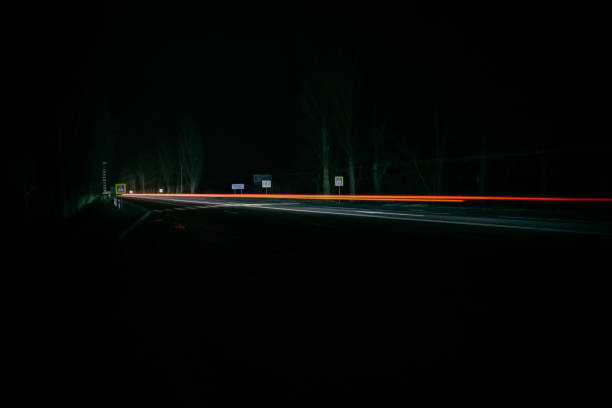istock Red and white lights from passing cars. Night highway. 1384581189