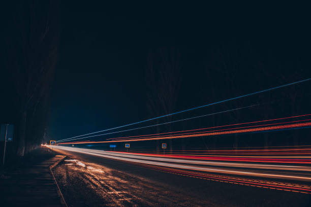 istock Red and white lights from passing cars. Night highway. 1384581214