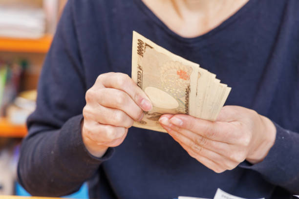 istock A woman counting money to make ends meet 1384582564