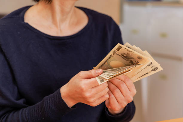 istock A woman counting money to make ends meet 1384582589