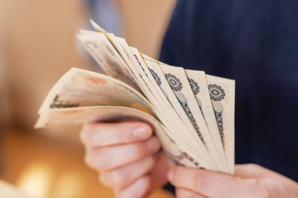 istock A woman counting money to make ends meet 1384583482