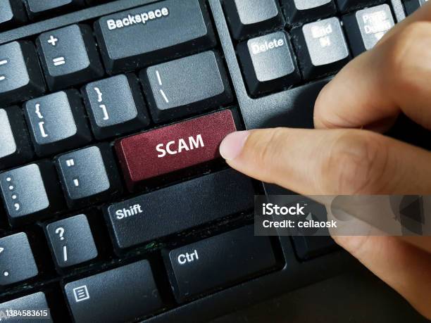 A Person Pressing The Keyboard Key With The Word Scam Stock Photo - Download Image Now