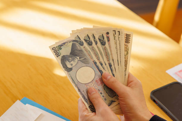 istock A woman counting money to make ends meet 1384583809
