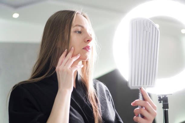 istock Beautiful young woman looking in the mirror 1384586825