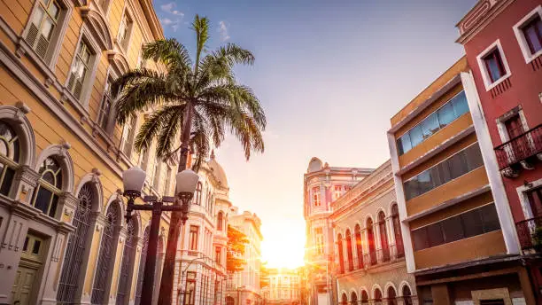 View of the historic architecture of the Brazilian city of Recife in the state of Pernambuco, Brazil showcasing its preserved colonial buildings on cobblestone streets at Recife Antigo neighborhood.